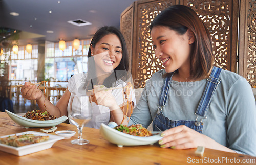 Image of Restaurant, girl friends and talking with food, noodles and cafe happy from bonding. Asian women, eating and plate together with friendship smile at a table hungry with chopsticks at Japanese bar