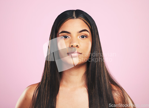 Image of Portrait, shampoo and hair with a woman on a pink background in studio for keratin treatment. Face, skincare or haircare with a confident young model at the salon for natural beauty or cosmetics