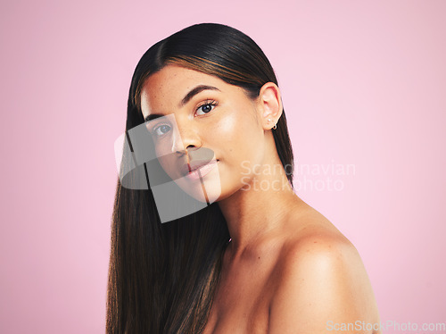 Image of Portrait, hair and a natural woman on a pink background in studio for shampoo treatment. Face, beauty or haircare with a confident young model at the salon for organic skincare or keratin cosmetics