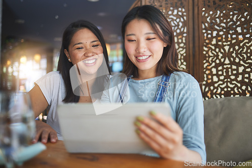 Image of Restaurant, tablet and Asian women for menu, food options and online order for lunch, meal or dinner. Coffee shop, cafe and happy friends on digital tech for social media review, website and app