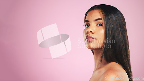 Image of Portrait, hair care and woman with growth, wellness and dermatology on a pink studio background. Face, person or model with skincare, cosmetics or luxury with self care, mockup space or spa treatment