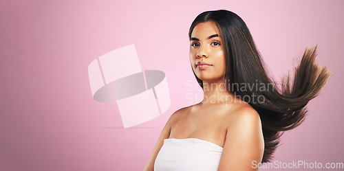 Image of Beauty, hair and woman in studio with mockup for texture, treatment or shine on pink background. Haircare, glow and female model with healthy growth, results and strand strength, keratin or cosmetics