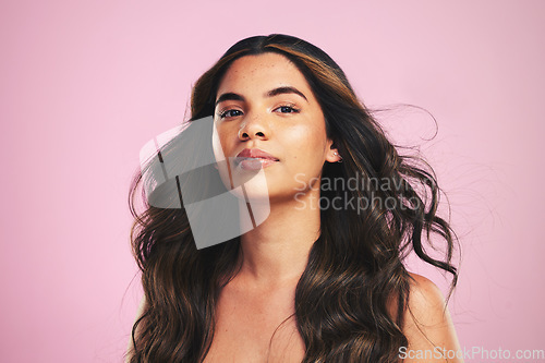 Image of Portrait, hair care and woman with cosmetics, luxury or dermatology on a pink studio background. Face, person or female with volume, aesthetic or salon treatment with makeup, skincare or healthy skin