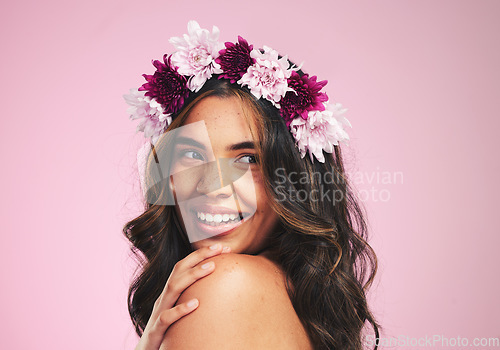 Image of Happy woman, flowers and thinking with crown in studio for natural beauty, skincare and plants on pink background. Face, model and floral wreath for sustainability, eco dermatology and hair cosmetics