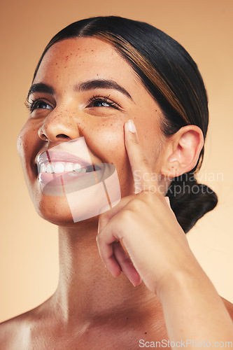 Image of Skincare, beauty and woman with finger on face for wellness, health and facial care in studio. Dermatology, spa and happy person on brown background in cosmetics, natural glow and satisfaction touch