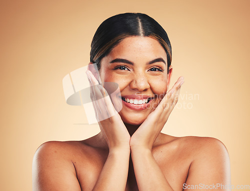 Image of Skincare, smile and hands on woman face in studio for cosmetic, wellness and dermatology on brown background. Beauty, portrait and lady model happy with glowing skin, results or self love cosmetology