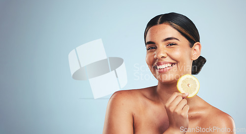 Image of Portrait, lemon and happy woman in studio for skincare, wellness or organic, beauty or skin detox on grey background, Fruit, smile and face of lady model with citrus facial for collagen or anti aging