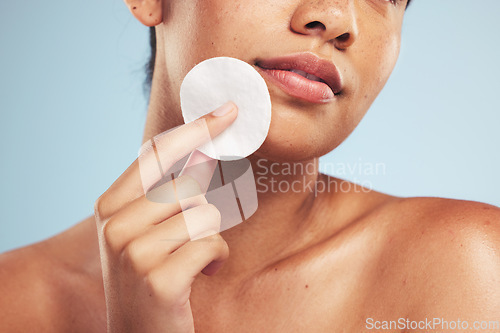 Image of Woman, cotton pad and closeup of face for cosmetics, aesthetic glow and grooming on studio background. Model, beauty and skincare with dermatology for cleaning facial makeup, shine and cosmetology