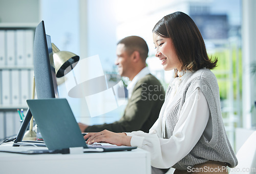 Image of Business, research and asian woman on laptop and computer in office for planning or strategy in coworking space. Online, search and happy female designer smile for creative, networking or design