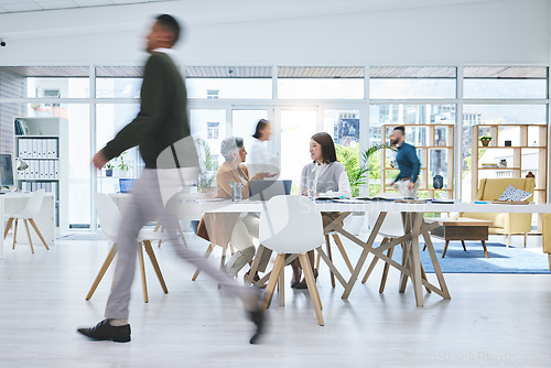 Image of Business people, walking and busy in meeting, planning and collaboration in office or workspace for startup or project. Professional worker, employees or group in speed or blur for creative teamwork