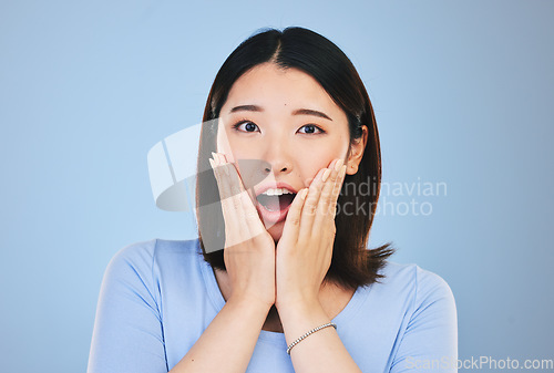 Image of Asian, portrait and woman with surprise from announcement, news or horror story on blue background in studio. Shock, face and person with wow deal, discount or emoji for crazy promotion and offer