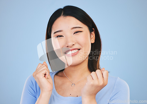 Image of Happy, Asian and portrait of a woman on a blue background for cosmetics face headshot. Smile, beauty and a girl or model with dental care, beautiful and makeup for cheerful personality in studio