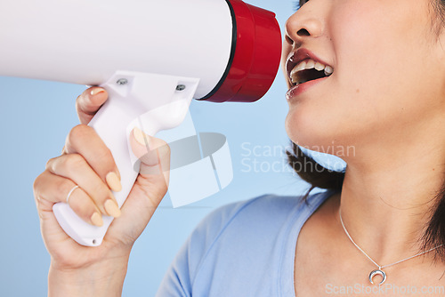 Image of Woman, megaphone and shout for protest, closeup and studio for freedom, justice or peace by blue background. Girl, student activist and loudspeaker for speech, presentation or human rights with audio