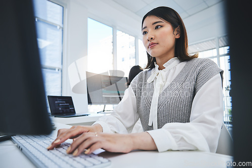 Image of Asian woman, computer and coding in software development or web design at the office. Female person or employee typing on desktop PC in programming, innovation or problem solving at the workplace