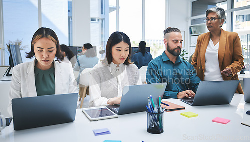 Image of Business people, laptop and meeting, productivity and creative group at marketing agency with research online. Man, women and diversity, working together and senior team leader with branding strategy