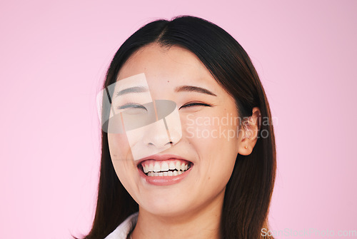 Image of Happy, portrait and asian woman laugh in studio with funny, joke or silly humor on pink background. Comic, smile and face of female model laughing to goofy, comedy or playful, good mood or positivity