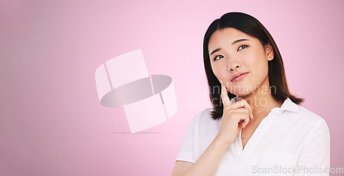 Image of Asian woman, thinking and decision on mockup in problem solving against a pink studio background. Female person with idea, solution or choice in memory, reminder or brainstorming on mock up space