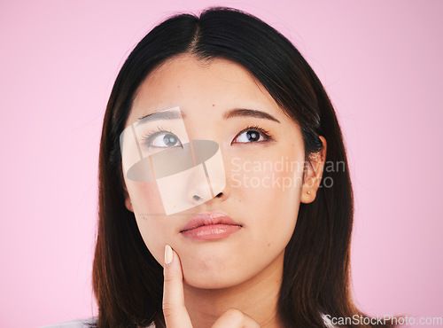 Image of Beauty woman, thinking and confused, ideas and cosmetics decision or skincare choice on pink background. Young asian person with skin care vision, makeup inspiration or dermatology question in studio