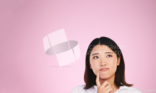 Image of Asian woman, thinking and mockup space in solution, memory or ideas against a pink studio background. Female person in problem solving, reminder or plan emoji in decision or brainstorming on mock up