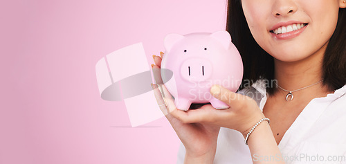 Image of Woman, piggy bank and mockup space in savings, investment or financial growth against a pink studio background. Female person, banner and hands holding piggybank in finance or profit on mock up