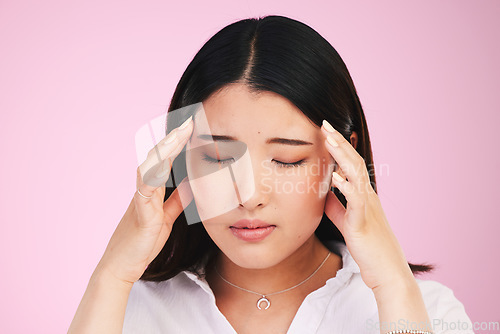 Image of Asian woman, headache and stress in anxiety, tired or burnout against a pink studio background. Frustrated, upset or unhappy female person with migraine, injury or mental health pain on mockup space