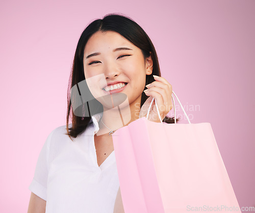 Image of Woman, shopping bag and retail, customer in portrait with purchase and smile isolated on pink background. Gift, store or boutique discount with fashion, commerce and happy, market and sale in studio