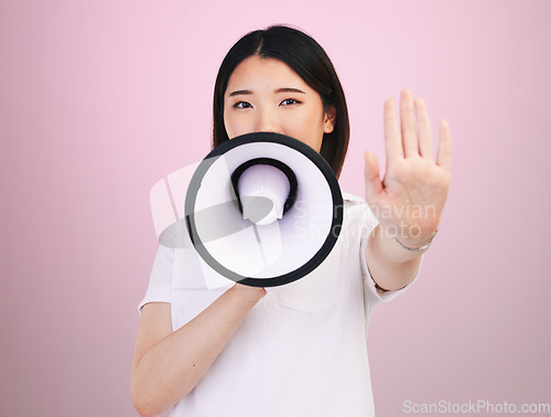 Image of Megaphone announcement, portrait and Asian woman with stop hand sign for justice, human rights rally and end racism. Warning speech, studio and Japanese female speaker revolution on pink background