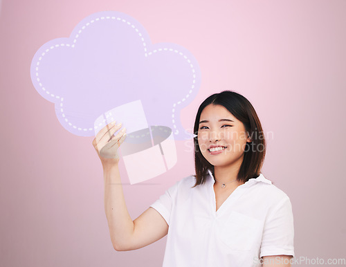 Image of Happy asian woman, portrait and speech bubble on mockup space against a pink studio background. Female person smile with shape, icon or symbol in communication, quote or social media on mock up