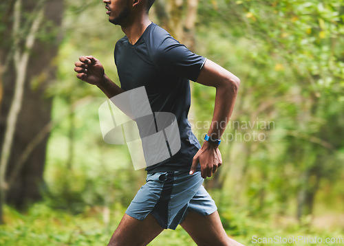 Image of Man, speed and running in park for action, motion blur and power of cardio workout in nature. Closeup, runner and sports athlete in race for marathon with energy, exercise or fast performance outdoor