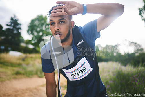 Image of Runner man, race and tired in nature, thinking and rest for sweat, breathe or vision in woods for triathlon. Athlete guy, face and idea for strategy, fatigue or burnout in forest, marathon or hiking]