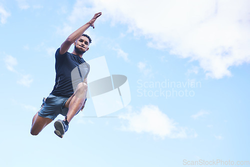 Image of Runner man, jump and sky with space for mockup, clouds and fitness in nature, action and freedom. Athlete guy, low angle and outdoor for workout, exercise and training with fast moving for health