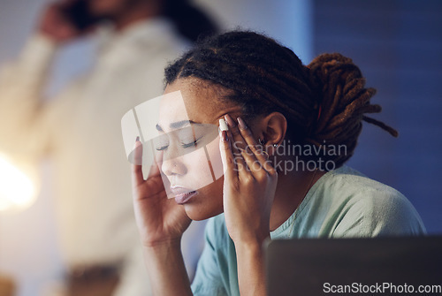 Image of Business woman, headache and stress in an office at night while working late on deadline. Tired African entrepreneur person with hands on head for pain, burnout or depression while thinking of work