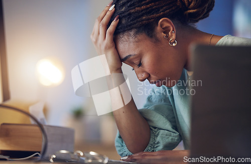 Image of Business woman, depression and stress in an office at night working late on deadline. Tired African entrepreneur person with hands on head for pain, burnout or regret for mistake or fail at work