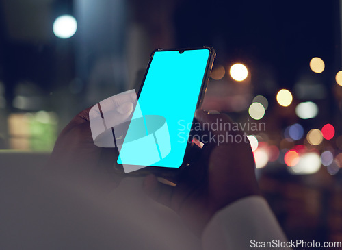 Image of Hands, green screen on phone for communication and a business person closeup in a city at night. Marketing, contact and mockup space with an employee scrolling on a touchscreen for mobile advertising