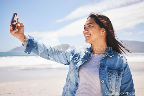 Image of Phone, selfie and happy woman on beach for holiday, vacation or summer in Indonesia or profile picture for social media. Person, smile and post memory of the ocean, sea or relax in nature for break