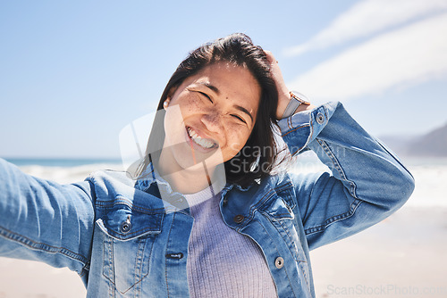 Image of Portrait, smile and selfie of woman at beach on holiday, vacation and travel. Face, happy and Asian person at ocean in profile picture, social media and influencer on trip at sea on mockup space.