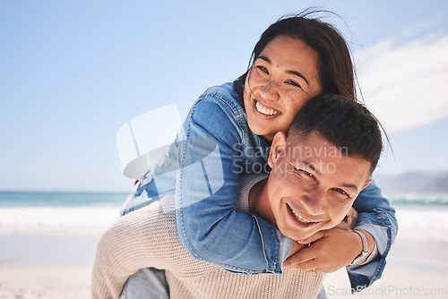 Image of Happy, piggyback and portrait of a couple at the beach for a date, love or vacation together. Summer, smile and a man and woman with a hug at the sea for a holiday, travel or bonding in marriage