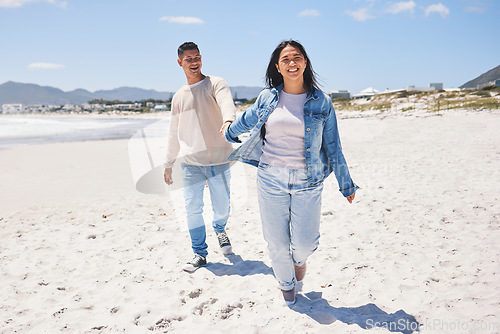 Image of Love, happy and holding hands with couple at beach for travel, summer vacation and romance together. Smile, relax and bonding with man and woman walking on seaside holiday for care, date or honeymoon