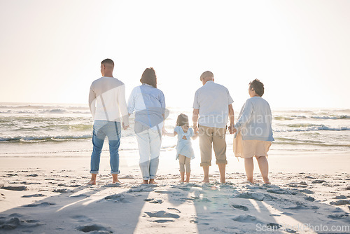 Image of Summer, relax and holding hands with big family on beach for vacation, bonding and love. Freedom, care and travel with group of people walking at seaside holiday for generations, happiness and mockup