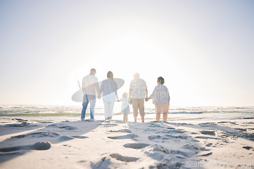 Image of Summer, travel and holding hands with big family on beach for vacation, bonding and love. Freedom, care and relax with group of people walking at seaside holiday for generations, happiness and mockup