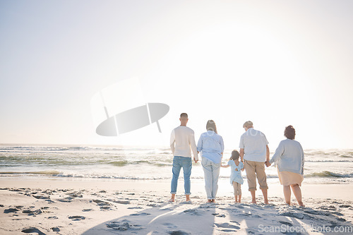 Image of Summer, space and holding hands with big family on beach for vacation, bonding and love. Freedom, care and relax with group of people walking at seaside holiday for generations, happiness and mockup