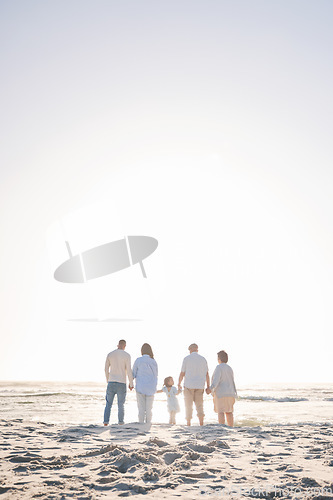 Image of Love, travel and holding hands with big family on beach for vacation, bonding and summer. Freedom, care and relax with group of people walking at seaside holiday for generations, happiness and mockup