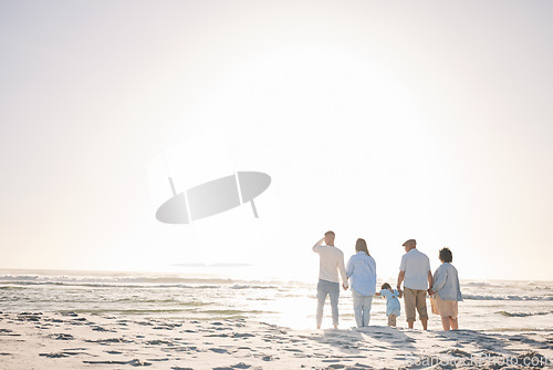 Image of Space, travel and holding hands with big family on beach for vacation, bonding and love. Summer, care and relax with group of people walking at seaside holiday for generations, happiness and mockup