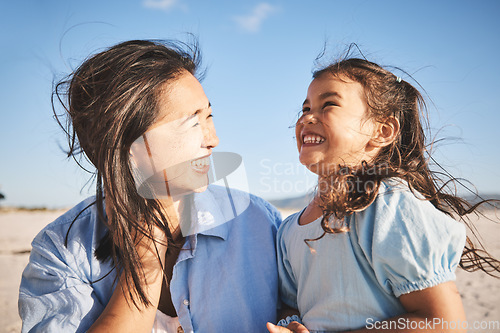 Image of Laughing, care and a mother and child at the beach for family, travel or summer freedom. Happy, young and a mom with a girl kid at the ocean for a holiday, bonding or together with love at the sea