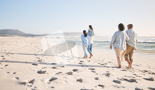 Image of Summer, travel and back of big family on beach for vacation, bonding and love. Freedom, care and relax with group of people walking at seaside holiday for generations, happiness and mockup space