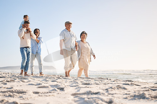 Image of Summer, travel and relax with big family on beach for vacation, bonding and love. Freedom, care and support with group of people walking at seaside holiday for generations, happiness and mockup space