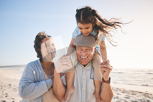 Image of Happy, beach and girl bonding with her grandparents on a tropical family vacation or adventure. Smile, sunset and child playing with her grandmother and grandfather by the ocean on holiday together.