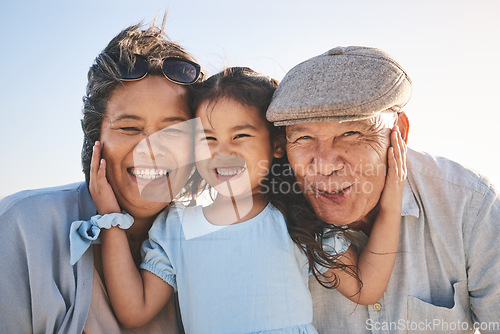 Image of Smile, sky and portrait of a girl with her grandparents in nature on a family vacation or holiday. Happy, love and child holding her grandmother and grandfather with care on an outdoor weekend trip.