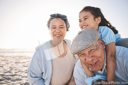 Image of Fun, beach and girl playing with her grandparents on a family vacation, adventure or holiday. Happy, smile and child on a piggyback ride and bonding with her grandmother and grandfather by the ocean.