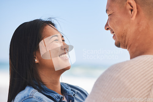 Image of Happy, couple and love at the beach together for travel, date or a vacation in the summer. Smile, marriage and a man and woman with care on a holiday, the sea for a honeymoon or outdoor walking